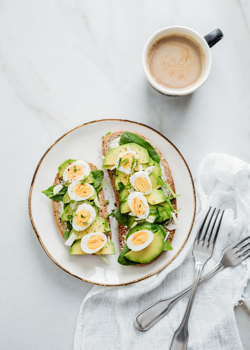 eggs and avocado on toast with coffee