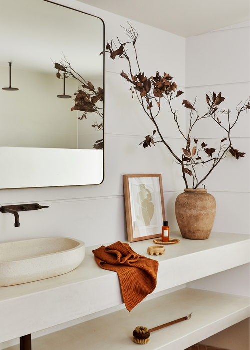 clean bathroom basin with linen towel and plant