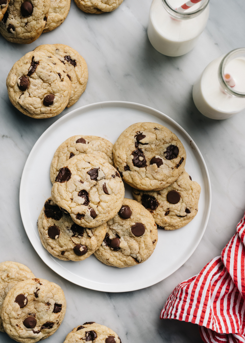 chocolate chip cookies and glasses of milk