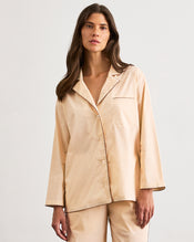 A woman with long brown hair wears the Bed Threads Vanilla & Espresso Piped Long Sleeve Shirt, posing against a plain white background and looking at the camera with a neutral expression. - view