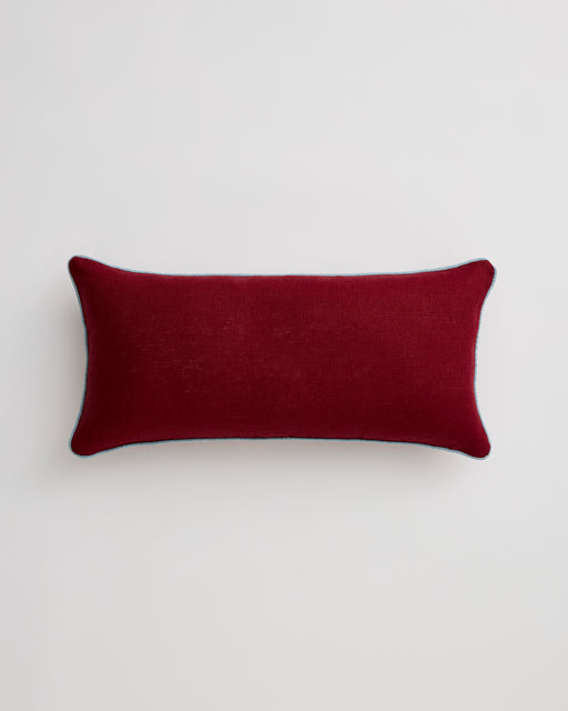 The Mulberry & Lagoon 100% French Flax Linen Piped Lumbar Cushion Cover by Bed Threads features a rectangular shape, deep red hue, subtle contrast piping, and softly rounded corners, shown on a plain white background.