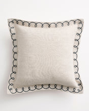 The Bed Threads Oatmeal & Charcoal 100% French Flax Linen Swirl Cushion Cover features a square design with a black embroidered swirl edge, crafted from textured linen for a modern minimalist look, shown on a white background. - view