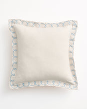 The Bed Threads Crème & Coast 100% French Flax Linen Swirl Cushion Cover features a square, off-white design with blue embroidered swirls along the edges, displayed on a plain white background. - view