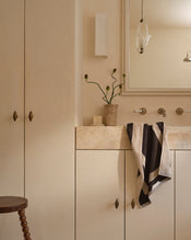 Neutral bathroom with cotton terry hand towel in oatmeal & charcoal hanging near sink. - view