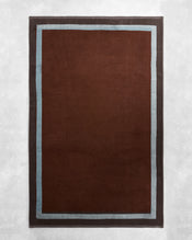 The Cacao & Lagoon Two-Toned 100% Cotton Terry Bath Sheet Bundle by Bed Threads features a dark brown center with a light blue stripe and dark gray border—ideal for a coordinated look when paired with plush bath towels. - view