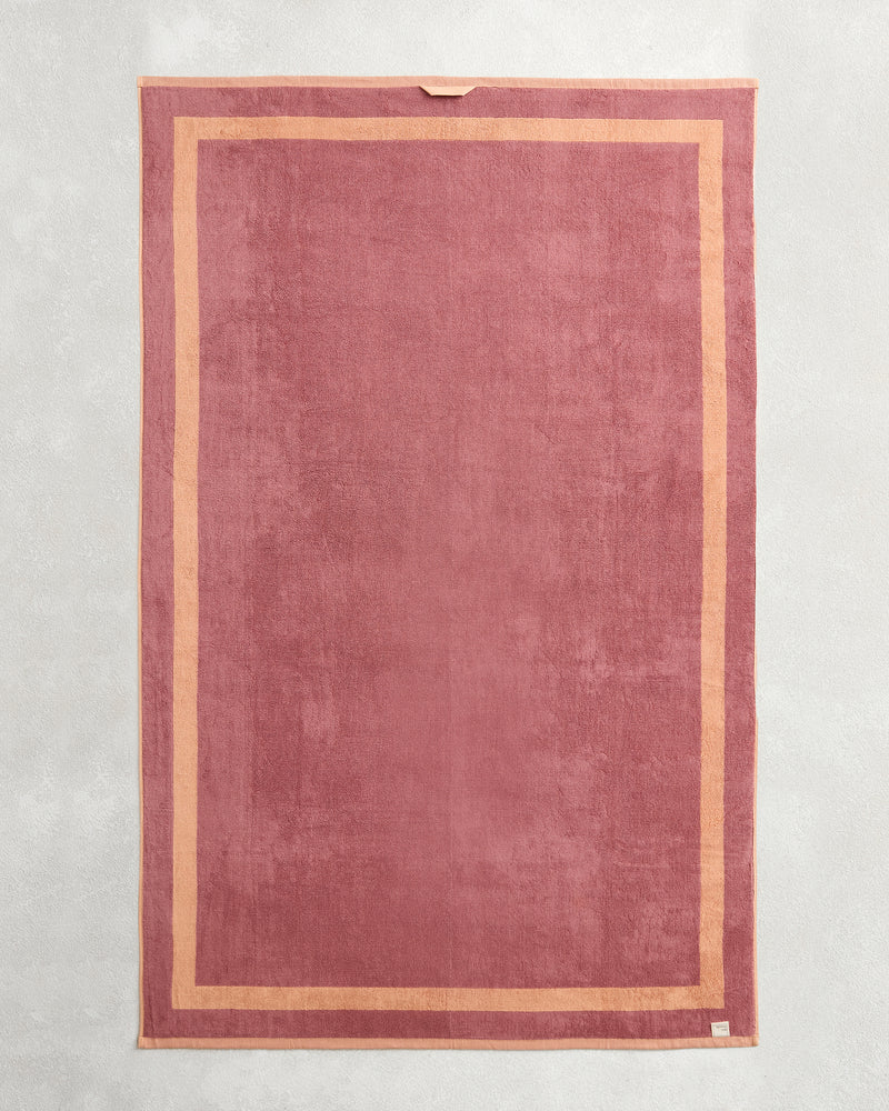 A set of two Bed Threads Terracotta & Pink Clay Two-Toned 100% Cotton Terry Bath Sheets, featuring a subtle lighter pink border, a corner loop, and sewn label—ideal for luxury bathrooms or spa-day essentials.