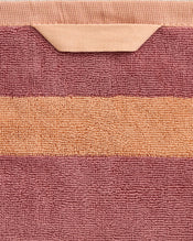 A detailed view of the Bed Threads Terracotta & Pink Clay Two-Toned 100% Cotton Terry Bath Sheet features a horizontal pink stripe on terracotta, a folded hanging loop, and a quick-drying design. - view