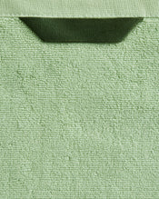 Close-up of Bed Threads' Apple 100% Cotton Terry Bath Towels (Set of Two), featuring a light green, textured looped surface and dark green hanging loop, showcasing their highly absorbent cotton quality. - view