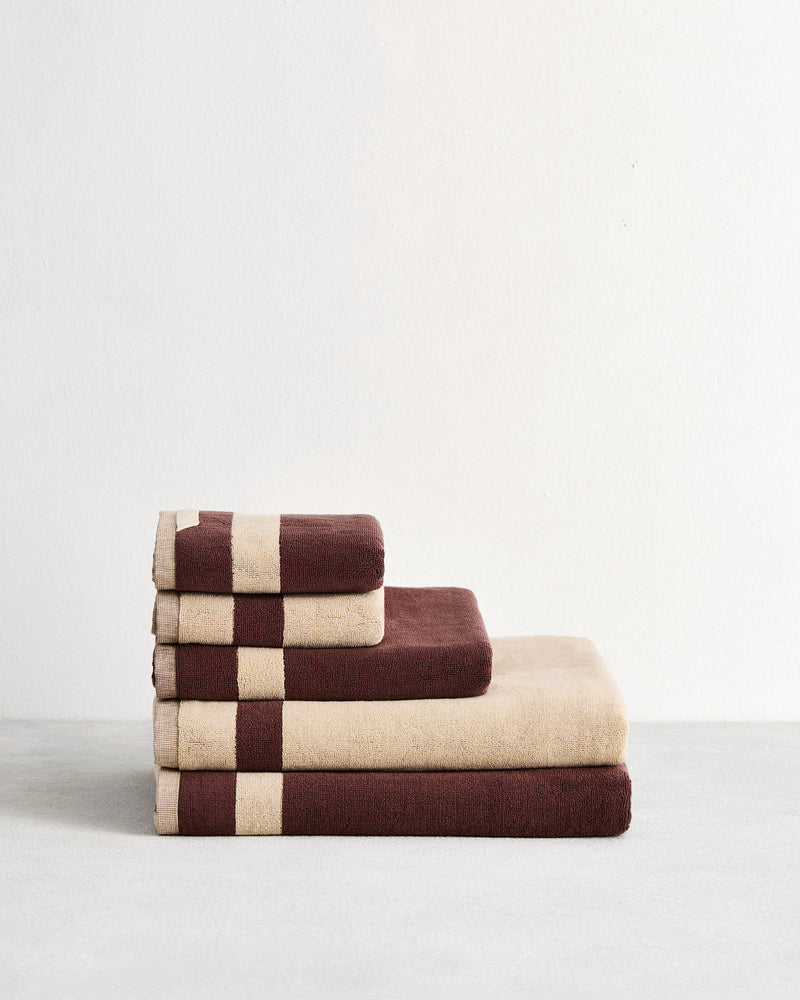 Stack of two cotton terry bath sheets in reversible colours creme and cacao. 