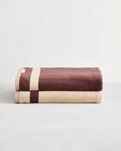 Stack of two cotton terry bath sheets in reversible colours creme and cacao.  - view