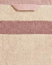 Close-up of a cotton terry bath towel in a creme colourway with a lavender border. - view